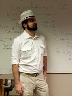 John Andrew Grillo in white suit and panama hat